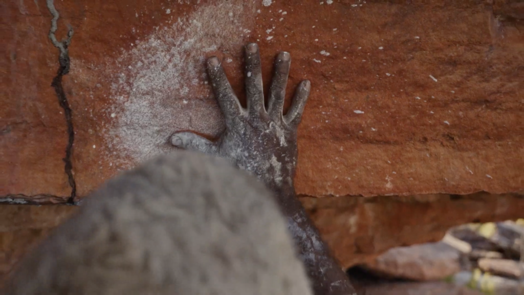 A hand placed on a rock